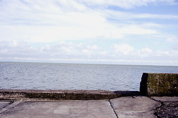 Image showing Old concrete pier for ships and sea sky background 