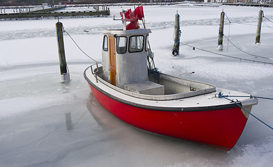 Image showing Tiny fishing boat in ice