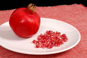 Image showing Pomegranate and seeds on white plate