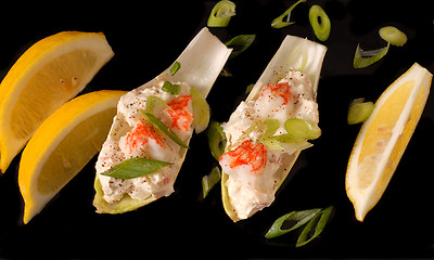 Image showing Crab salad on endive leaves with lemon