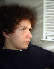 Image showing Boy sitting by the window