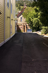 Image showing Yellow Sidings of a Building in an Alley