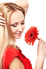 Image showing Young lady with red gerbera