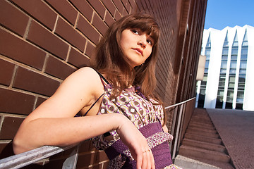 Image showing Stylish young woman leans her elbows