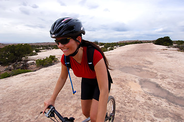 Image showing Smiling woman on bike