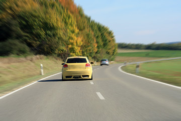 Image showing silver and yellow car driving on the road