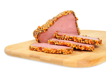 Image showing Piece of a ham with spices on a wooden board