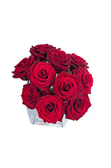Image showing Bunch of red rose flowers in a small vase (top view)