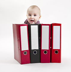 Image showing young child hiding behind ring file