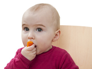 Image showing child in red shirt eating