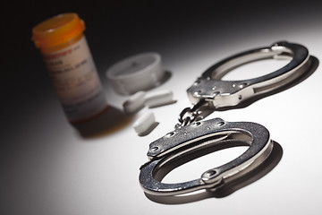 Image showing Handcuffs, Medicine Bottle and Pills Under Spot Light