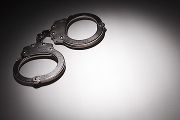 Image showing Abstract Pair of Handcuffs Under Spot Light - Text Room