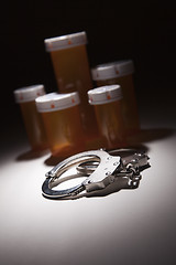 Image showing Handcuffs, Medicine Bottle and Pills Under Spot Light