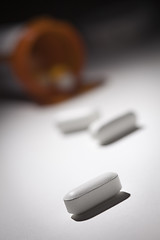 Image showing Medicine Bottle and Pills Under Spot Light