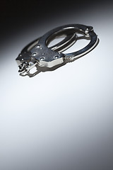 Image showing Abstract Pair of Handcuffs Under Spot Light - Text Room