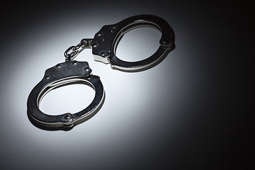 Image showing Abstract Pair of Handcuffs Under Spot Light - Text Room