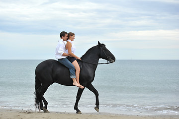 Image showing couple and  horse on the beach