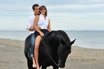 Image showing couple and  horse on the beach