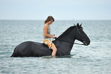 Image showing woman and  horse in the sea