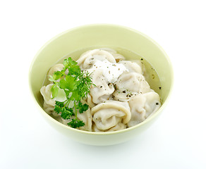 Image showing Meat pelmeni with sour cream and greens 