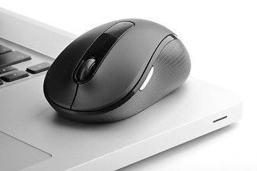 Image showing Steel laptop and black computer mouse 