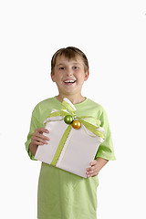 Image showing Smiling boy holding a gift