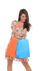 Image showing Portrait of stunning young woman carrying shopping bags