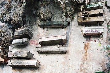 Image showing hanging coffins on cliff