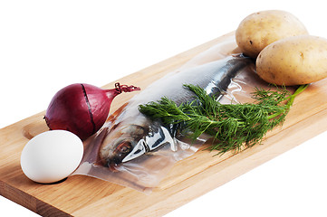 Image showing Vegetables and a salty herring on a kitchen board
