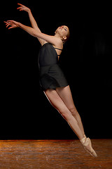 Image showing Beautiful Ballerina Leaping in Studio on Black Background