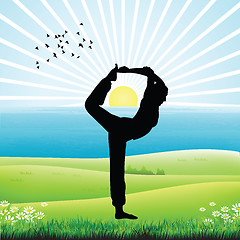 Image showing silhouette of human doing yoga, sunrise background