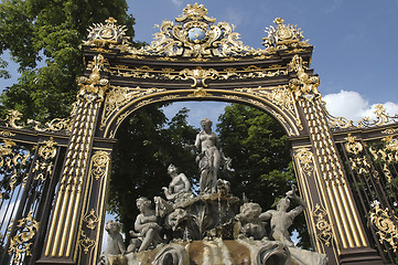 Image showing fountain framed by a golden gate