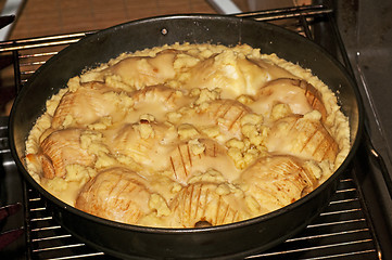 Image showing apple cake in the oven