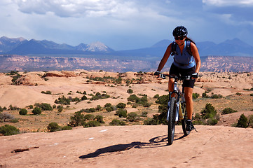 Image showing Woman mountain biking