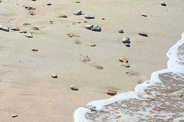 Image showing Footprints at the beach among the stones