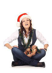 Image showing Girl in a santa hat with christmas decoration