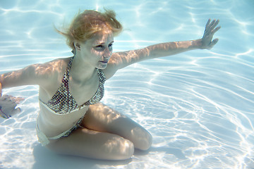 Image showing Girl swimming underwater in a swimming pool 