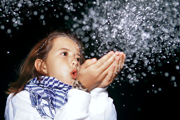 Image showing Girl Blowing Snow 