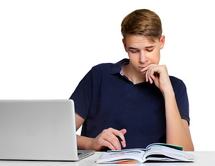Image showing Teenage boy working on the laptop