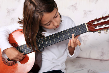 Image showing Young girl play classical guitar