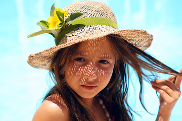 Image showing Little girl wearing a hat near pool