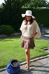 Image showing Pretty woman in hat and poncho