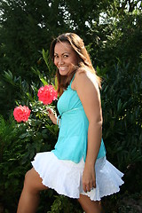 Image showing Pretty girl among roses