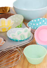 Image showing Variety of cupcake liners with wire whisk