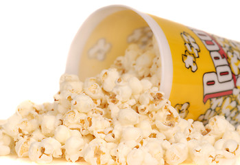 Image showing Container of popcorn with popcorn spilling out