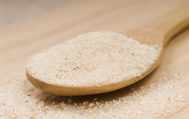 Image showing Fresh grits on a wooden spoon