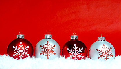 Image showing Christmas ornaments on snow