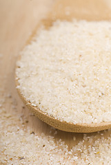 Image showing Fresh grits on a wooden spoon