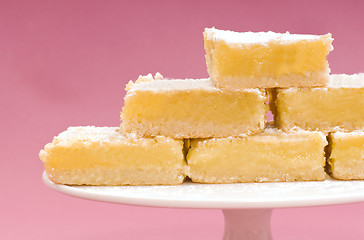 Image showing Freshly baked lemon squares on a white cake stand