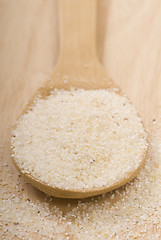 Image showing Fresh grits on a wooden spoon